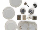 a lot of white plates and silverware on a table