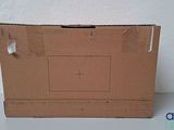 a cardboard box with a hole in it on a table