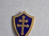 a close up of a blue and gold shield with a cross on it