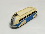 a toy bus that is sitting on a white surface