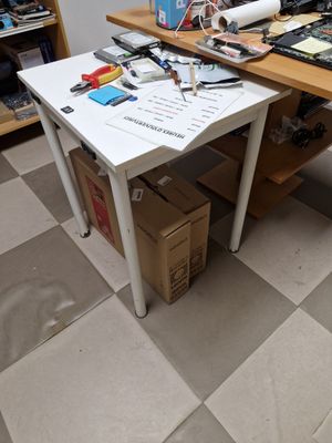 a white table with a laptop on it in a room