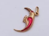 a picture of a red and gold charm with a bird on it
