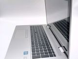 a silver laptop with a blue sticker on the screen