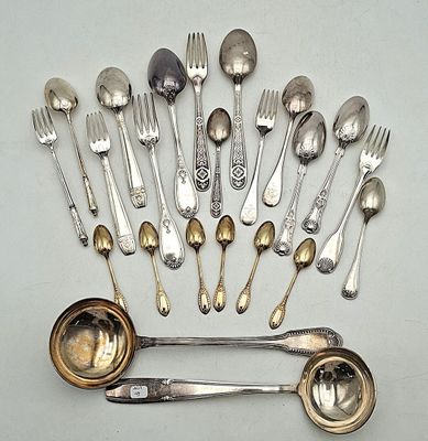 a lot of silver spoons and spoons on the table