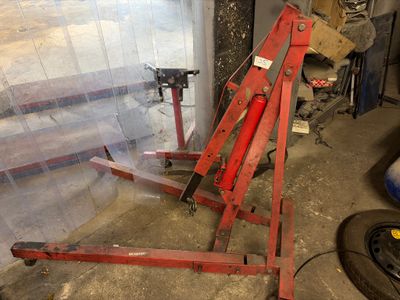 a red machine that is sitting in a garage