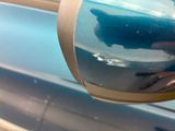 a reflection of a car in the side mirror of a blue car