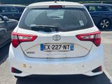 the back of a white toyota yaris parked in a parking lot