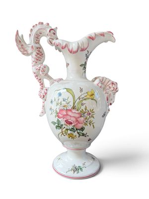 a white vase with pink flowers on it on a white background