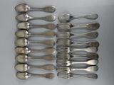 a lot of silver spoons and forks on a table