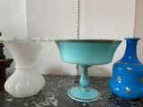 two vases sitting on a table next to each other