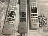 three remote controls sitting on top of each other