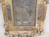 a picture of a gold frame with a picture on it