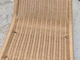 a wicker chair that is laying on the ground