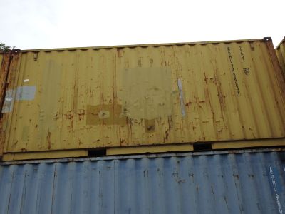 a yellow and blue container sitting on top of a building