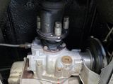 a close up view of a carburetor in the engine compartment