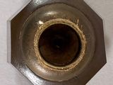 a close up of a metal object with a hole in it