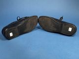 a pair of black shoes on a blue background