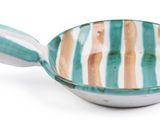 a bowl with a spoon in it on a white surface