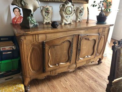 a wooden cabinet with a clock on top of it