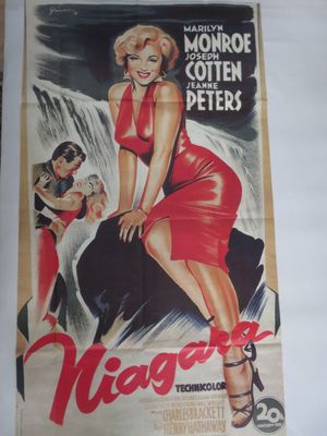 une vieille affiche de cinéma représentant une femme en robe rouge