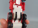 a person holding a toy car in their hand