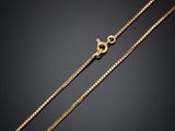 a gold chain on a black background