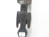 an image of a wooden sculpture of a man with a basket on his head