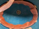 a blue hat with a leather band and a brown leather band
