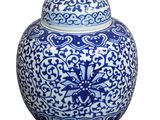 a blue and white vase with a lid on a white background
