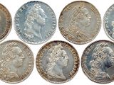 a group of six silver coins with heads of people on them