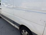 a white van that is parked on the side of the road