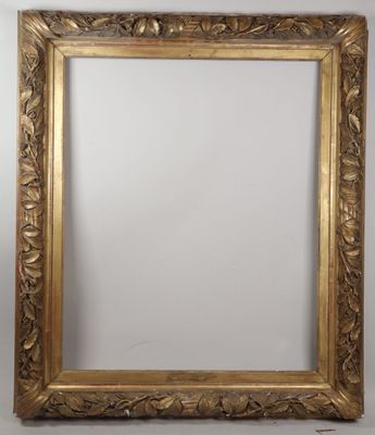 a gold framed mirror with a floral design on the edge