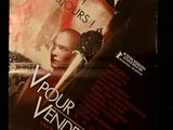movie poster of a woman holding a knife in front of a man