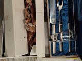 a box with a knife, fork and a plate inside of it