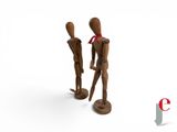 two wooden mannequins standing next to each other on a white surface