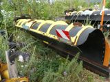 a yellow and black train engine sitting in the grass