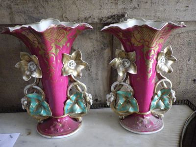 two vases that are sitting on a table