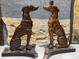 two statues of a dog and a cat sitting on a table
