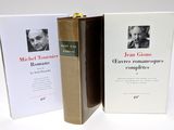 two books on a white table with a picture of a man