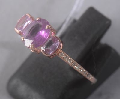 an image of a close up of a ring with a pink stone