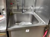 a sink with a faucet and a dishwasher in it