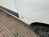 a white van that is parked on the side of the road
