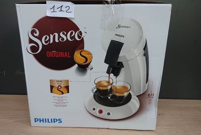 packaging of a coffee machine sitting on top of a wooden table