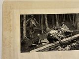 a black and white photo of a group of men working in the woods