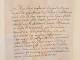 un vieux papier sur lequel il y a des inscriptions est accroché au mur