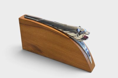 a wooden box with a metal object on it