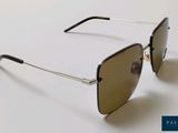 a close up of a pair of sunglasses on a white surface