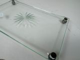 a glass shelf with a clock on top of it