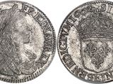 a silver coin with a crown on top of it