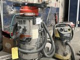 two vacuums sitting next to each other on the floor